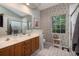 Bathroom with double sinks, vanity, tile floor and floral wallpaper at 1578 Harborsun Dr, Charleston, SC 29412