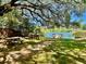 Community space with picnic tables, benches, and a serene lake view, creating a perfect spot for relaxation at 1578 Harborsun Dr, Charleston, SC 29412