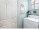 Laundry room with white washer and dryer, shelving and window at 1578 Harborsun Dr, Charleston, SC 29412