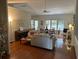 Open-concept living room with hardwood floors, vaulted ceiling, and large windows at 1578 Harborsun Dr, Charleston, SC 29412