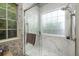 Bathroom shower with glass door and marble tile at 1578 Harborsun Dr, Charleston, SC 29412