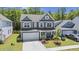 Two-story home with a two-car garage, mature trees, landscaping, and a well-maintained lawn at 160 Cherry Grove Dr, Summerville, SC 29483