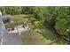 Aerial view of the fenced-in backyard with a wooden playset, lush lawn, and mature trees at 160 Cherry Grove Dr, Summerville, SC 29483