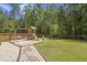 Spacious backyard featuring a wooden playset, lush grass, and mature trees at 160 Cherry Grove Dr, Summerville, SC 29483