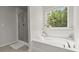 Bright bathroom showcasing a separate glass shower and a relaxing soaking tub next to a window at 160 Cherry Grove Dr, Summerville, SC 29483