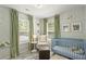 Charming Bedroom with patterned wallpaper, a blue crib, and cozy seating area with lots of natural light at 160 Cherry Grove Dr, Summerville, SC 29483
