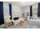 Bedroom with a white crib, a white couch with blue pillows, and a colorful rug at 160 Cherry Grove Dr, Summerville, SC 29483