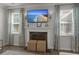 Beautiful fireplace with mantle and flatscreen TV, flanked by windows and floral drapes providing ample sunlight at 160 Cherry Grove Dr, Summerville, SC 29483