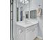 Bright bathroom with a white vanity, sink, and mirror reflecting the neutral-colored walls at 1600 Long Grove Drive # 811, Mount Pleasant, SC 29464