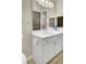Well-lit bathroom with white cabinetry, chrome hardware, and large vanity mirror at 1600 Long Grove Drive # 811, Mount Pleasant, SC 29464