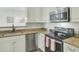 Well-lit kitchen featuring stainless steel appliances, granite countertops, and white cabinetry for a modern design at 1600 Long Grove Drive # 811, Mount Pleasant, SC 29464