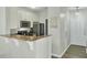 Open kitchen with granite countertops, stainless steel appliances, and sleek overhead microwave at 1600 Long Grove Drive # 811, Mount Pleasant, SC 29464