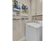 Functional laundry area with organized shelving, cabinets, and a modern washing machine at 1600 Long Grove Drive # 811, Mount Pleasant, SC 29464
