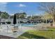Resort-style pool area with lounge chairs, umbrellas, and beautifully landscaped surroundings at 1600 Long Grove Drive # 811, Mount Pleasant, SC 29464