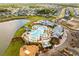 Aerial view showcasing a community pool, playground, parking, and lake, surrounded by lush landscaping and beautiful homes at 169 Callibluff Dr, Summerville, SC 29486