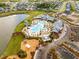 Community aerial view featuring a pool, playground, parking, and a lake, surrounded by lush landscaping and various homes at 169 Callibluff Dr, Summerville, SC 29486