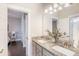 Bathroom featuring double sinks with granite countertop, modern lighting, and an open doorway to the bedroom at 169 Callibluff Dr, Summerville, SC 29486