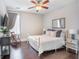 Stylish bedroom with hardwood floors, a vintage rocking chair, tv and decoratively appointed side tables at 169 Callibluff Dr, Summerville, SC 29486