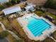 Aerial view of the community pool with lounge seating, splashpad, and covered seating area surrounded by landscaping at 169 Callibluff Dr, Summerville, SC 29486