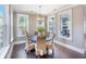 Charming dining room with large windows, a round table, and wicker chairs, creating an inviting atmosphere at 169 Callibluff Dr, Summerville, SC 29486