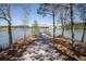 Scenic view of a community dock on a tranquil lake, surrounded by trees and offering a peaceful retreat at 169 Callibluff Dr, Summerville, SC 29486