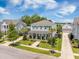 Charming two-story home featuring a welcoming front porch, lush landscaping, and a well-manicured lawn at 169 Callibluff Dr, Summerville, SC 29486