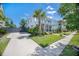 Charming home exterior with a well-manicured lawn, inviting front porch, and beautifully landscaped yard at 169 Callibluff Dr, Summerville, SC 29486