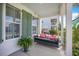 Inviting front porch features a swing bed with pillows and scenic views, ideal for relaxing and unwinding at 169 Callibluff Dr, Summerville, SC 29486