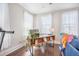 Bright home office with a wooden desk, hardwood floors, and three windows with natural light at 169 Callibluff Dr, Summerville, SC 29486