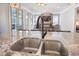 Close-up of the kitchen sink, showcasing granite countertops and a view into the open living space at 169 Callibluff Dr, Summerville, SC 29486