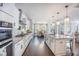 Bright, open kitchen with white cabinets, granite countertops, stainless steel appliances, and hardwood floors at 169 Callibluff Dr, Summerville, SC 29486