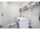 Bright laundry room with front loading washer and dryer and ample storage space on overhead shelving at 169 Callibluff Dr, Summerville, SC 29486