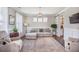 Comfortable living room with a large sectional sofa, patterned rug, and bright windows, offering a relaxing space at 169 Callibluff Dr, Summerville, SC 29486