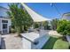 Outdoor kitchen area with modern grill and sink under sunshade at 169 Callibluff Dr, Summerville, SC 29486