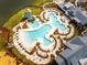 Aerial view highlighting an inviting resort-style community pool with a slide and plenty of lounge chairs for relaxation at 169 Callibluff Dr, Summerville, SC 29486