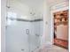 Modern shower with glass door, white tile, and a view into the walk-in closet at 169 Callibluff Dr, Summerville, SC 29486