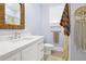 Well-lit bathroom featuring modern fixtures, a decorative mirror, and stylish décor at 1701 A Palmetto Blvd, Edisto Island, SC 29438
