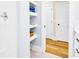 Bathroom detail with open shelves for storage and a view to a hall with hardwood flooring at 1701 A Palmetto Blvd, Edisto Island, SC 29438