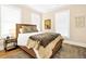Comfortable bedroom with stylish bedding, a cozy rug, and natural light from the windows at 1701 A Palmetto Blvd, Edisto Island, SC 29438