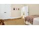 Tastefully decorated bedroom with hardwood floors, ample closet space, and an open doorway to a sunny area at 1701 A Palmetto Blvd, Edisto Island, SC 29438