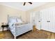 Well-appointed bedroom with hardwood floors, neutral decor, and view to ensuite bath at 1701 A Palmetto Blvd, Edisto Island, SC 29438