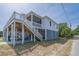 Beautiful exterior view of a coastal home with stairs, highlighting its inviting design at 1701 A Palmetto Blvd, Edisto Island, SC 29438