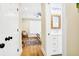 Hallway leads to a well-lit bedroom and bathroom with a decorative mirror and vanity at 1701 A Palmetto Blvd, Edisto Island, SC 29438