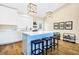Bright kitchen features a large island with seating, white cabinets, and modern pendant lighting at 1701 A Palmetto Blvd, Edisto Island, SC 29438