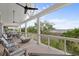 Relaxing back porch features comfortable seating, a modern fire pit, and views of the marshland at 1801 Landfall Way, Seabrook Island, SC 29455