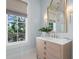 Elegant bathroom with a stylish vanity, gold fixtures, and natural light at 1801 Landfall Way, Seabrook Island, SC 29455