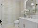 Elegant bathroom featuring a marble vanity, decorative mirror, stylish faucet, and wallpaper at 1801 Landfall Way, Seabrook Island, SC 29455