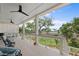 Relaxing covered porch with cushioned seating, ceiling fans, and scenic marsh views at 1801 Landfall Way, Seabrook Island, SC 29455