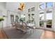 Bright dining room with large windows, hardwood floors, and a modern light fixture at 1801 Landfall Way, Seabrook Island, SC 29455
