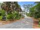 Beautiful home with a long driveway, lush landscaping, and inviting curb appeal at 1801 Landfall Way, Seabrook Island, SC 29455
